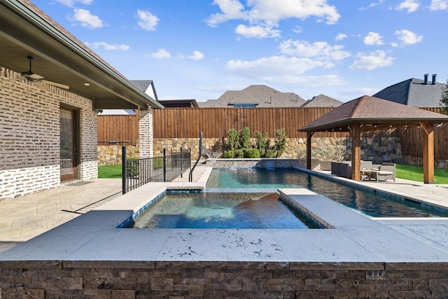 view of pool with pool water feature, a patio, an in ground hot tub, and a gazebo