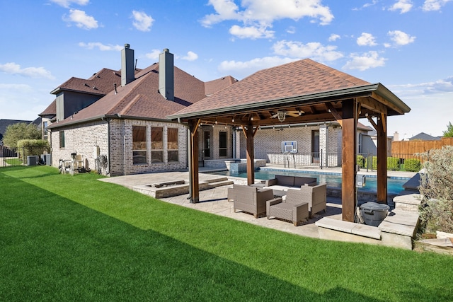 rear view of house featuring ceiling fan, a fenced in pool, a patio, a lawn, and outdoor lounge area