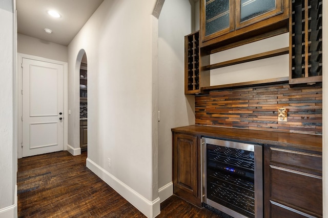 1240 Concho Trl, Prosper, TX 75078 - indoor dry bar with beverage cooler, arched walkways, and dark wood finished floors