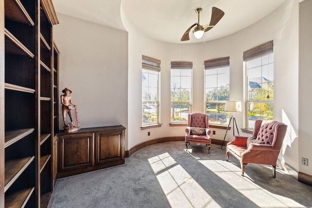 sitting room featuring light carpet and ceiling fan