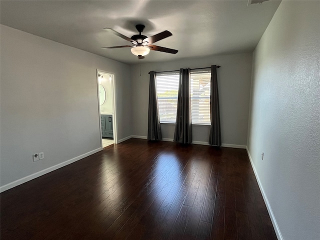 unfurnished room with ceiling fan and dark hardwood / wood-style flooring