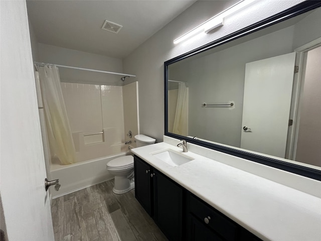 full bathroom with vanity, toilet, shower / bath combo with shower curtain, and hardwood / wood-style floors