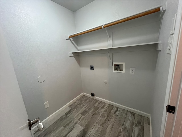 washroom with hookup for a washing machine, hardwood / wood-style flooring, hookup for an electric dryer, and gas dryer hookup