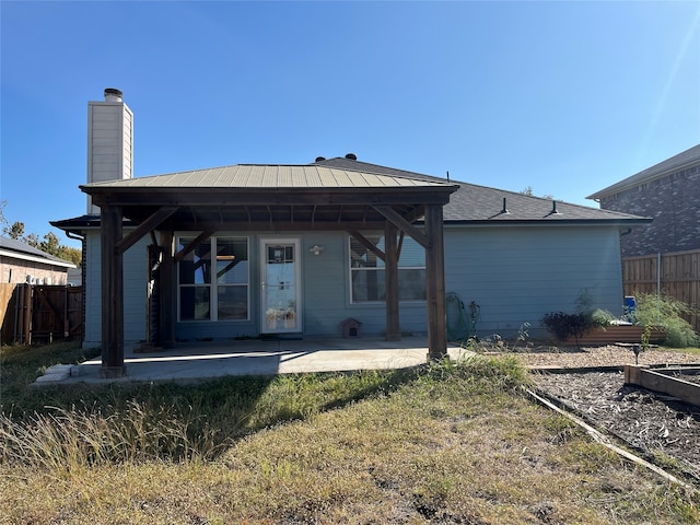 back of property with a patio