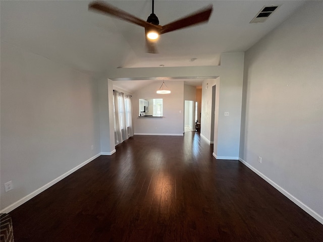 unfurnished living room featuring vaulted ceiling and dark hardwood / wood-style flooring