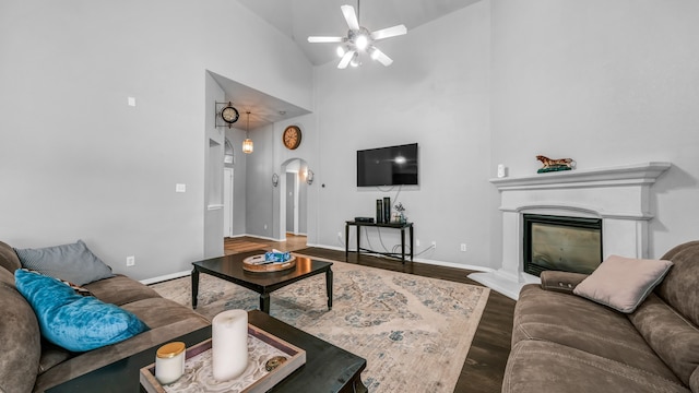 living room featuring high vaulted ceiling, wood-type flooring, and ceiling fan