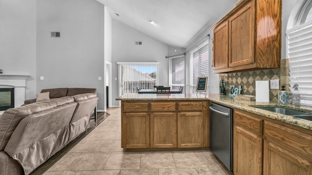 kitchen featuring dishwasher, decorative backsplash, kitchen peninsula, light tile patterned floors, and high vaulted ceiling