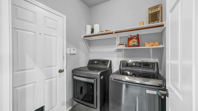 laundry room with washing machine and clothes dryer