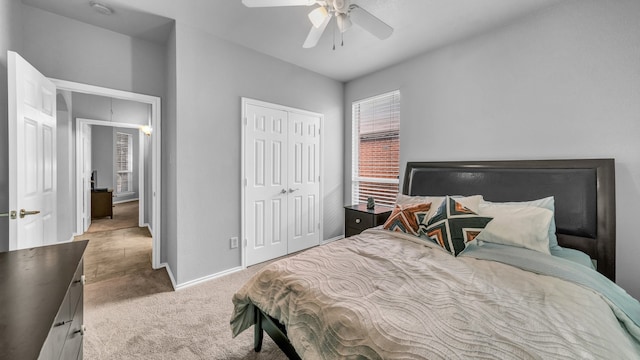 carpeted bedroom featuring a closet and ceiling fan