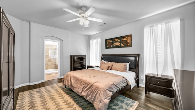 bedroom featuring ceiling fan, dark hardwood / wood-style flooring, and ensuite bathroom