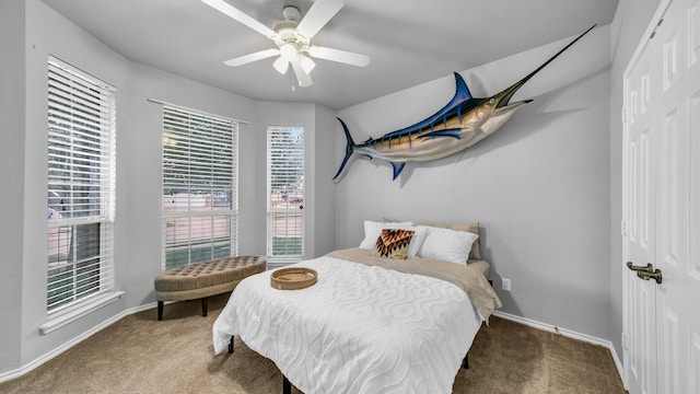 carpeted bedroom with a closet and ceiling fan