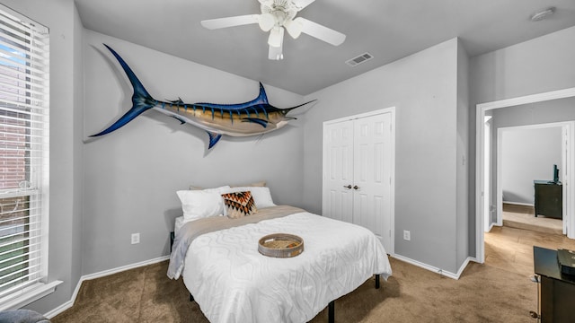 carpeted bedroom with a closet and ceiling fan