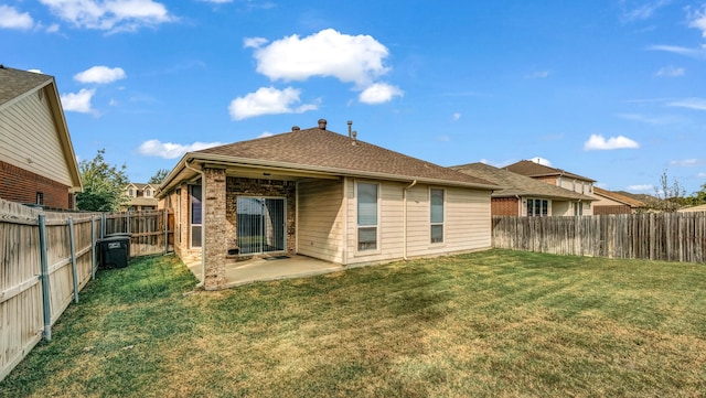 back of property featuring a patio area and a lawn