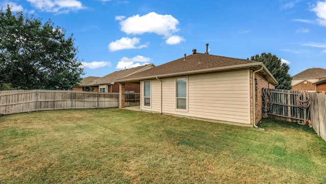 rear view of house with a yard