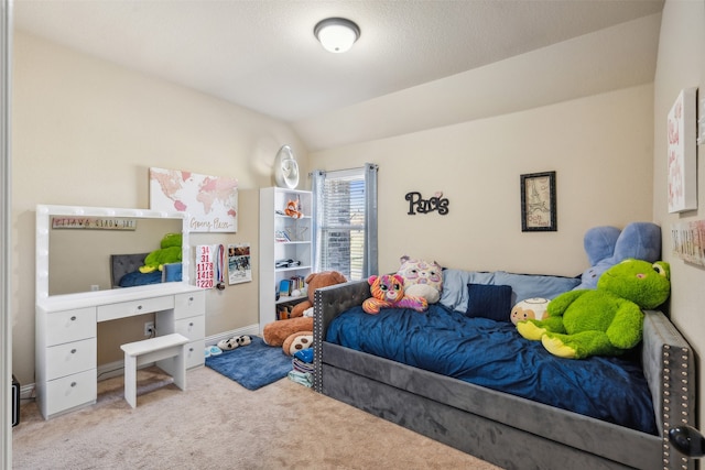 carpeted bedroom with lofted ceiling