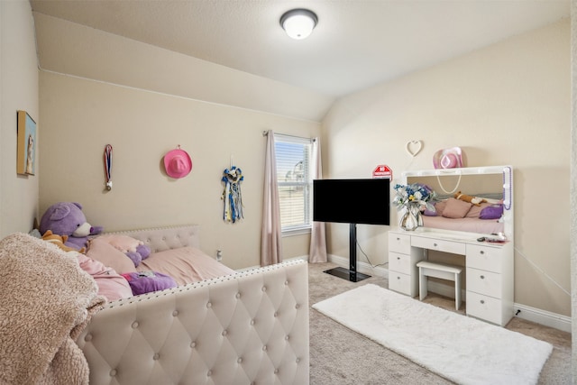 bedroom with lofted ceiling and carpet