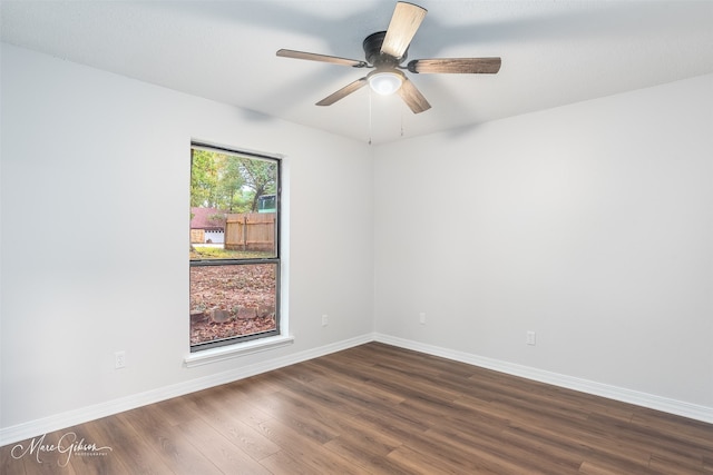 unfurnished room featuring ceiling fan and dark hardwood / wood-style flooring