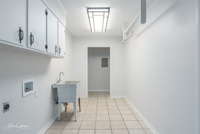 washroom with washer hookup, cabinets, hookup for an electric dryer, electric panel, and light tile patterned flooring