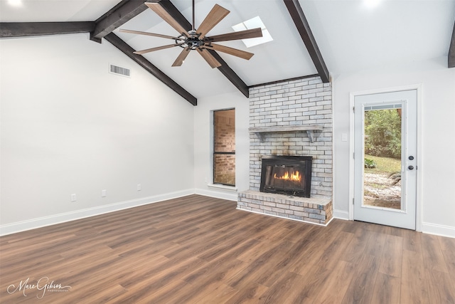 unfurnished living room featuring lofted ceiling with beams, ceiling fan, dark hardwood / wood-style flooring, and a fireplace