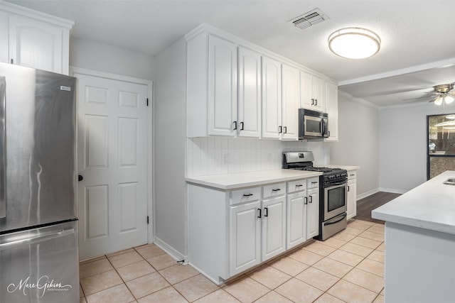 kitchen with white cabinetry, light tile patterned floors, and stainless steel appliances