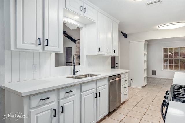 kitchen featuring dishwasher, white cabinets, sink, decorative backsplash, and gas range oven