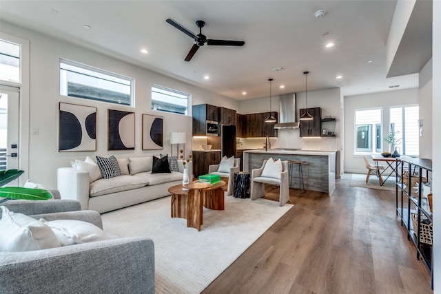 living room featuring light hardwood / wood-style floors and ceiling fan