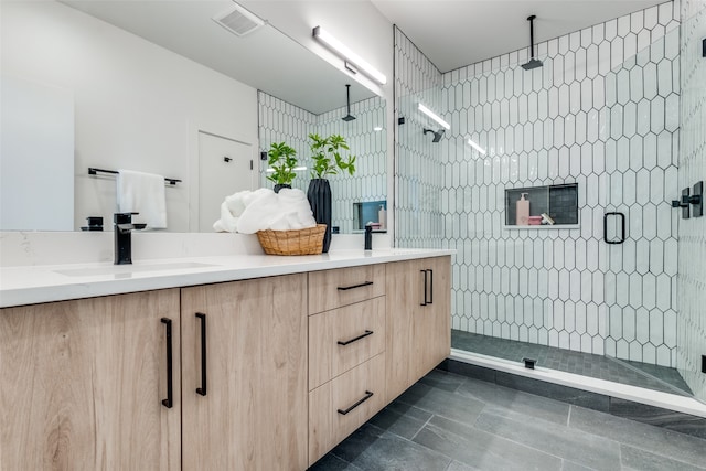 bathroom featuring vanity, tile patterned flooring, and a shower with door