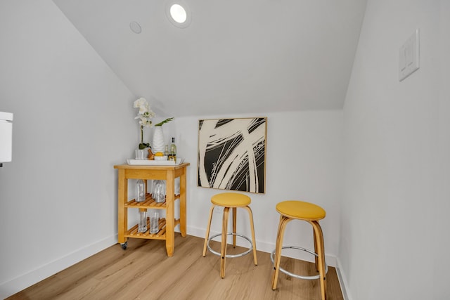 interior space featuring vaulted ceiling and light wood-type flooring