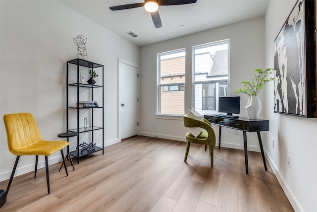 office space with light wood-type flooring and ceiling fan