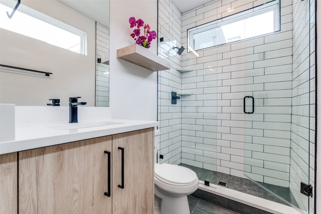 bathroom featuring vanity, tile patterned flooring, toilet, and an enclosed shower