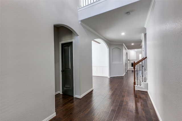 corridor featuring ornamental molding and dark wood-type flooring