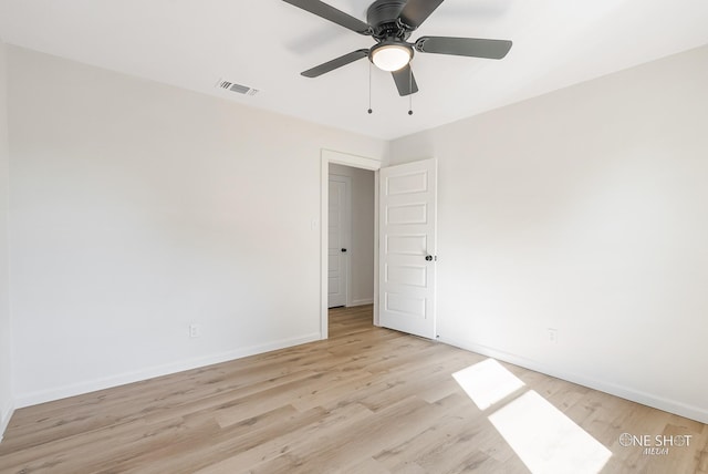 spare room featuring light hardwood / wood-style floors and ceiling fan