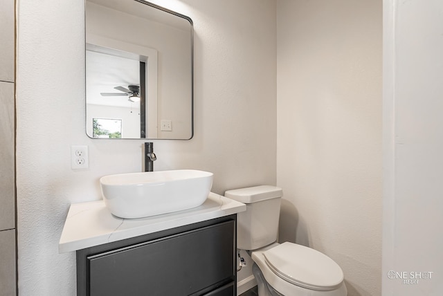 bathroom featuring vanity, toilet, and ceiling fan