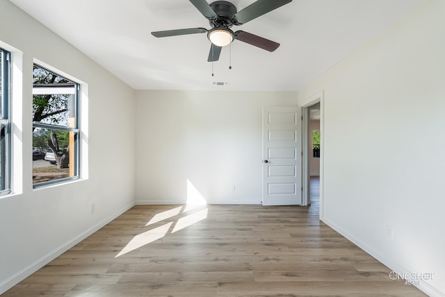 unfurnished room with ceiling fan and light hardwood / wood-style flooring