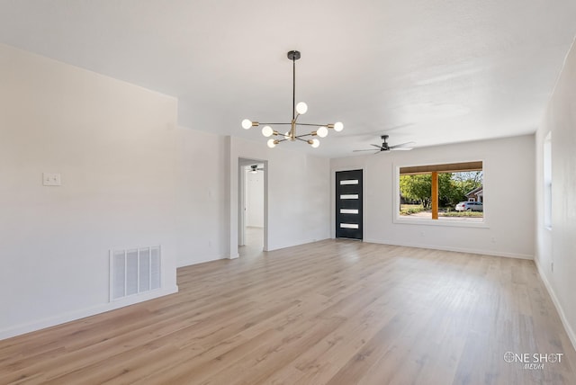 interior space featuring light hardwood / wood-style flooring and ceiling fan with notable chandelier