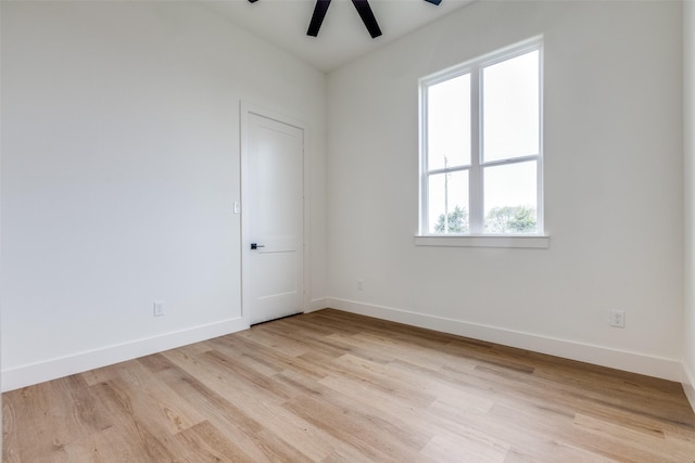 empty room featuring ceiling fan, a healthy amount of sunlight, and light hardwood / wood-style floors