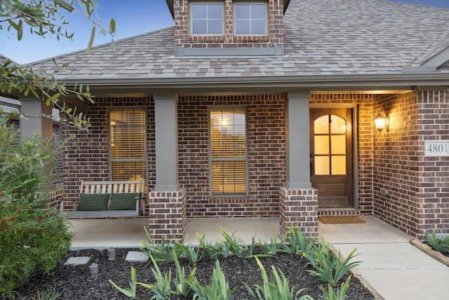 doorway to property featuring covered porch