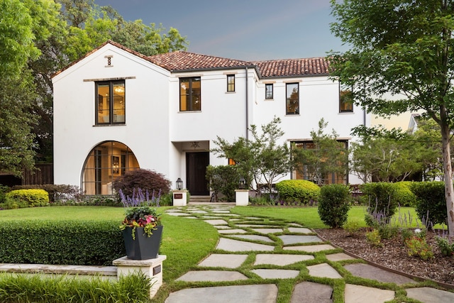 mediterranean / spanish house featuring a front yard