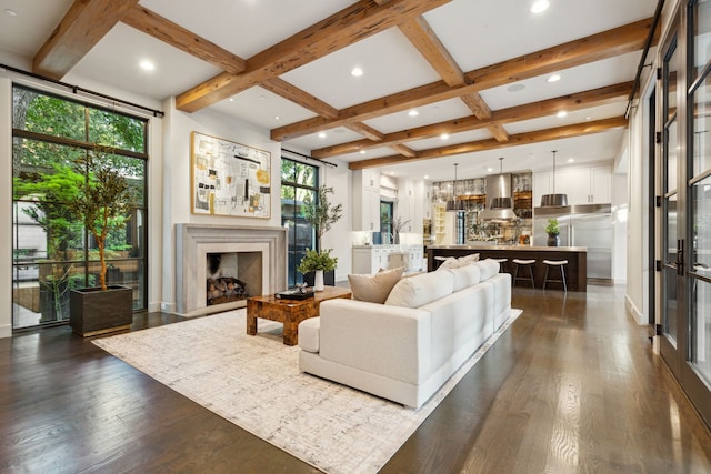 living room featuring beamed ceiling, coffered ceiling, and dark hardwood / wood-style floors