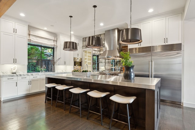 kitchen featuring extractor fan, white cabinetry, stainless steel appliances, and dark hardwood / wood-style flooring