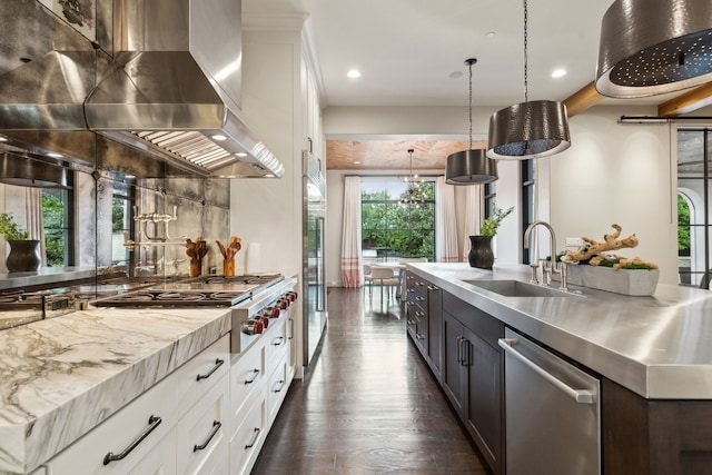 kitchen featuring decorative backsplash, dark hardwood / wood-style floors, sink, stainless steel dishwasher, and white cabinets