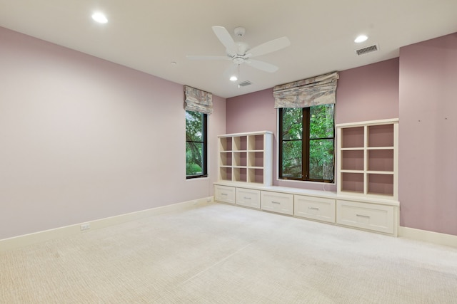 carpeted spare room with ceiling fan