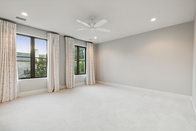 empty room featuring light colored carpet and ceiling fan