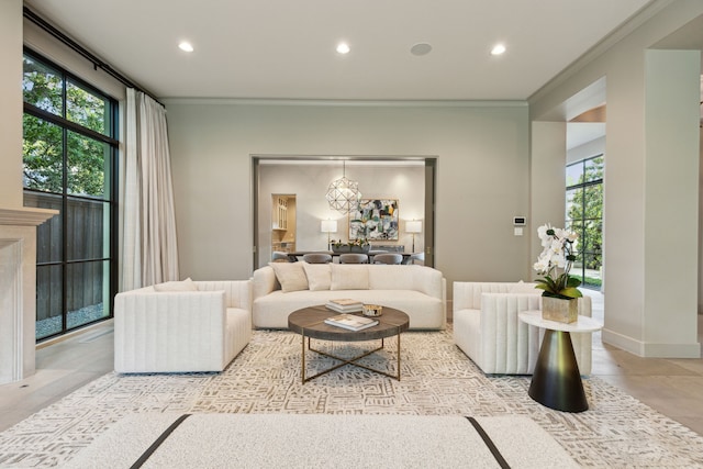 tiled living room with ornamental molding, a chandelier, and a wealth of natural light