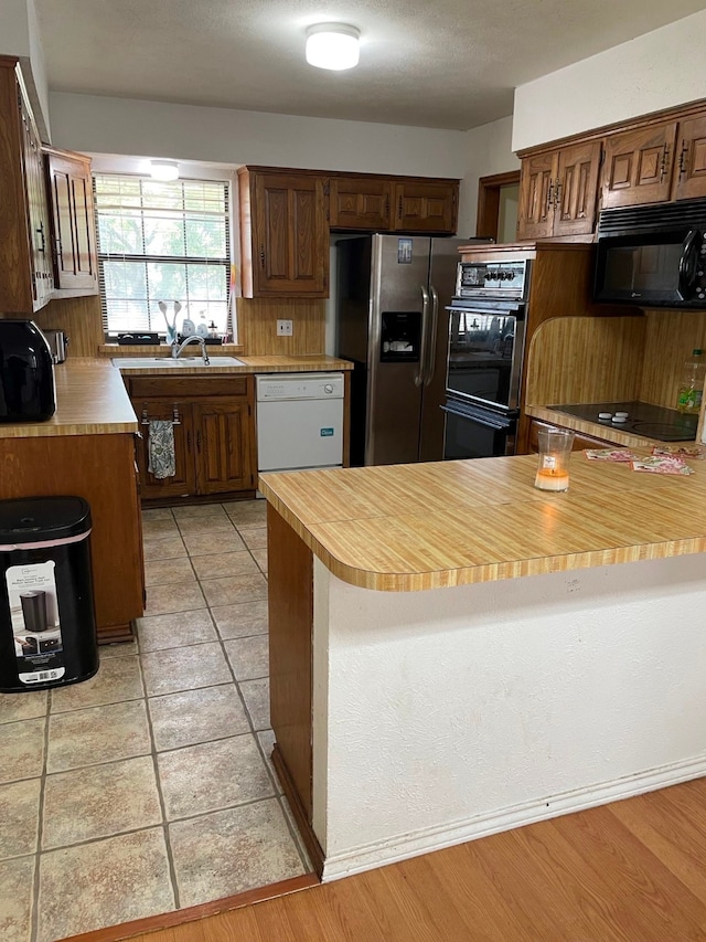 kitchen featuring light hardwood / wood-style floors and black appliances