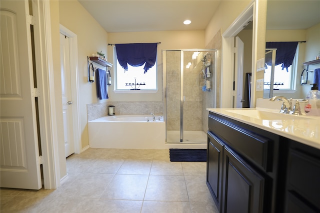 bathroom with vanity, a wealth of natural light, shower with separate bathtub, and tile patterned flooring