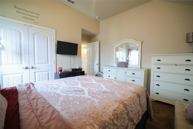 bedroom with a closet, carpet flooring, and vaulted ceiling