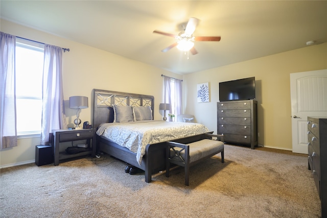 bedroom featuring carpet, multiple windows, and ceiling fan