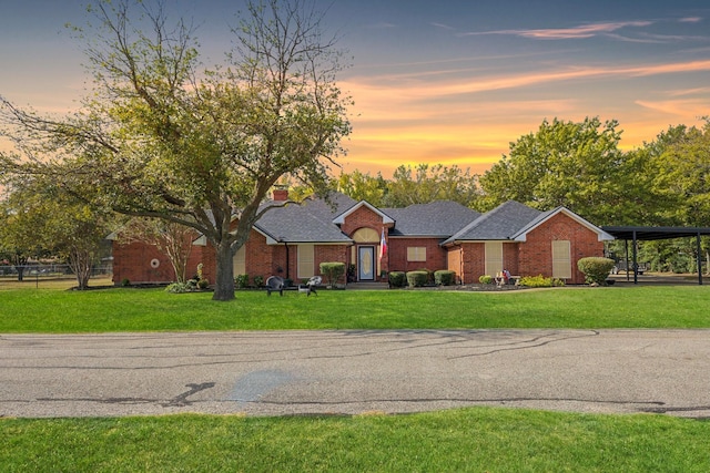 single story home with a carport and a lawn