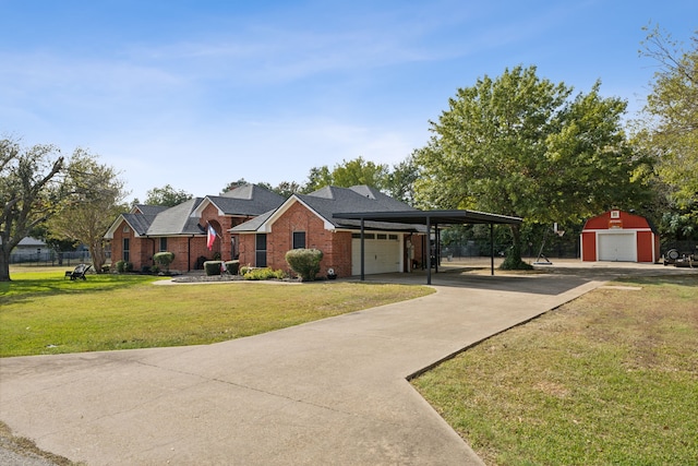 view of front of home featuring a carport, an outdoor structure, and a front yard